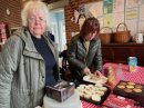 Steph sorting dessert, Liam's grandma cutting bread.