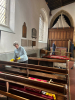 Brenda polishing pews.